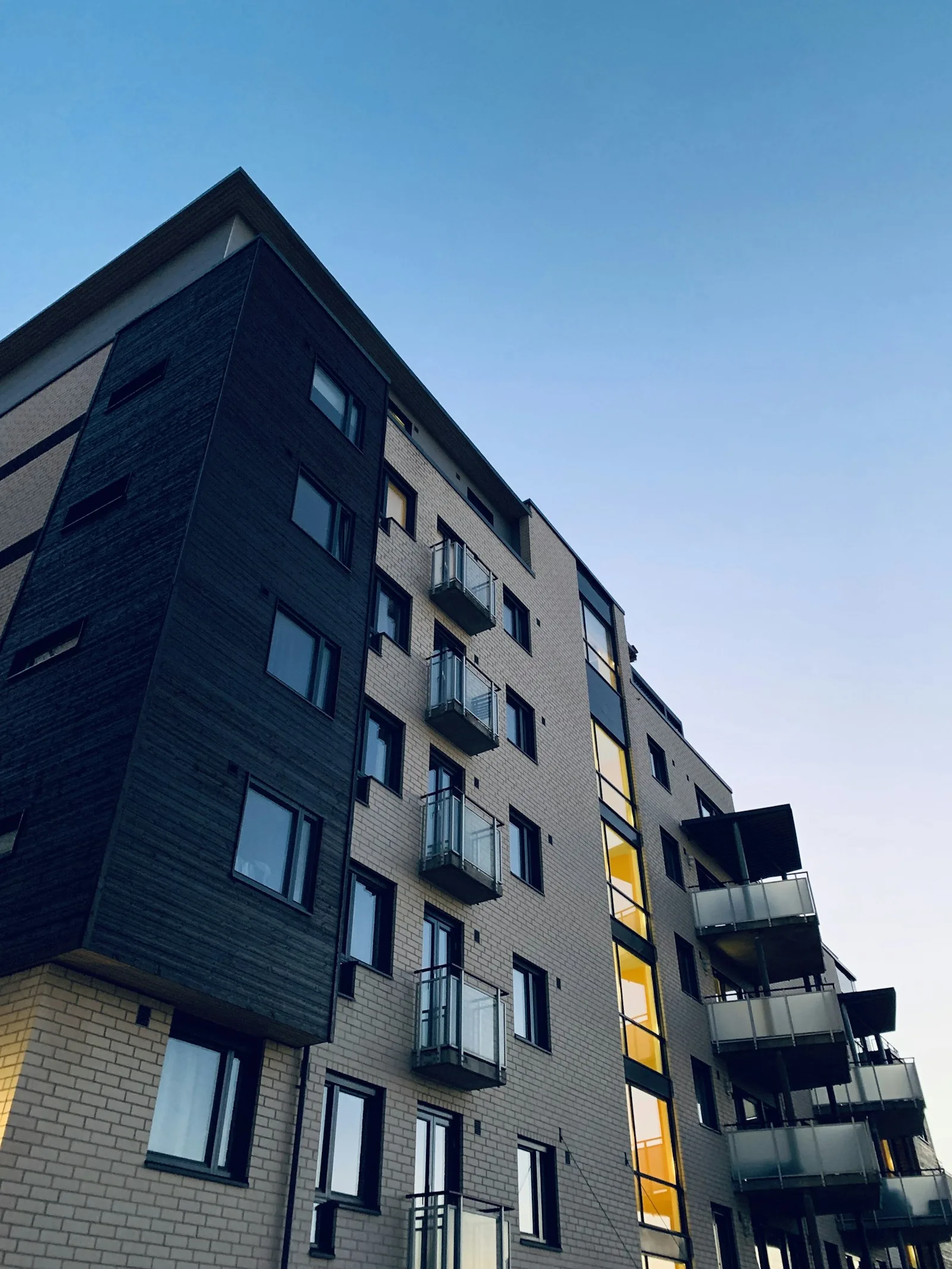 Contemporary apartment building with brick and dark cladding